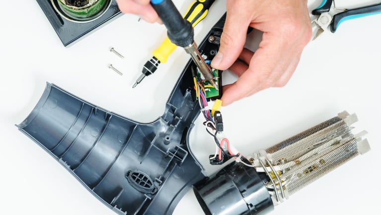 a person is holding a pair of scissors and a pair of scissors