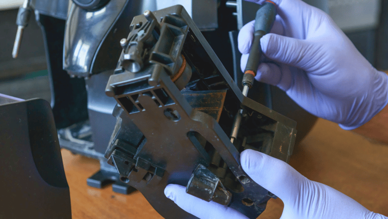 a person in gloves and gloves holding a machine