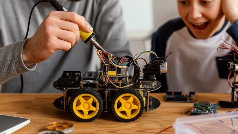 a man and a boy are building a robotic car