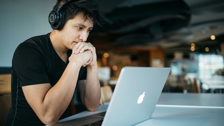 a man in headphones and headphones sitting at a table