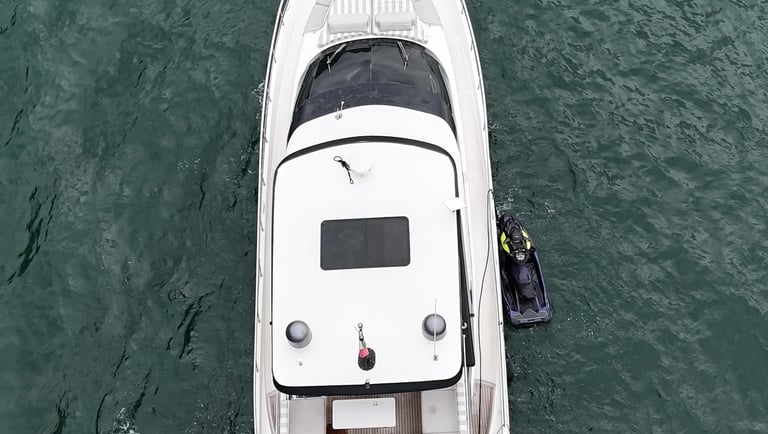 a boat with a man standing on the water