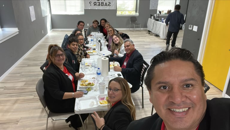 Diverse professional group enjoying a catered business lunch and meeting in a modern office.