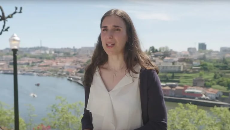 a woman in a white dress and a black jacket