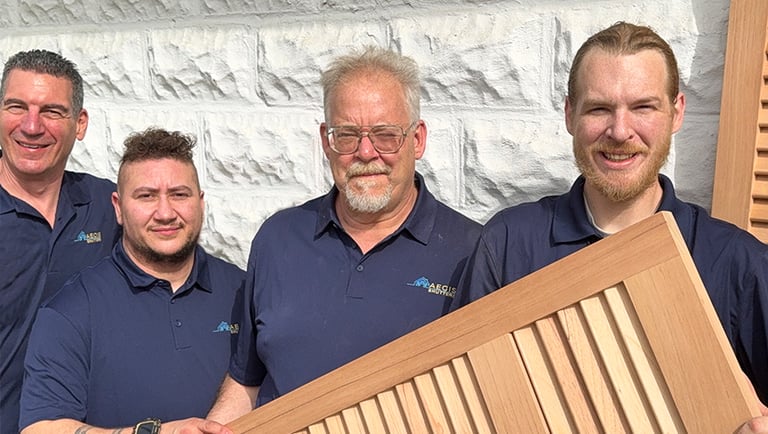 The Aegis Team holding one of their exterior shutters