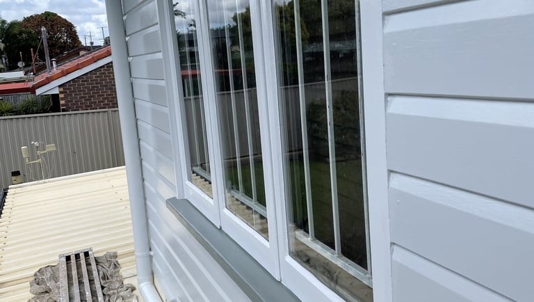 Freshly painted window frame and exterior wall after house repainting in Zillmere