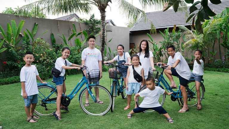 Extended family playful group moment at Lumbini Villas Jimbaran Bali during relaxed outdoor photography session