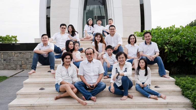 Large extended family portrait sitting together at The Ritz-Carlton Bali during a family photography session