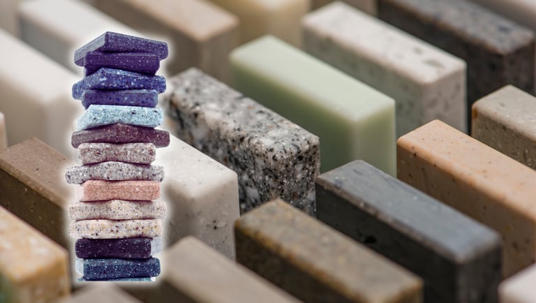 Several granite models in the background and, to the left, a pile of different granites.