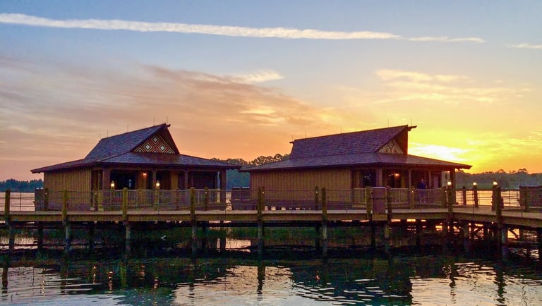 Disney's Polynesian Village Resort Bungalows on Seven Seas Lagoon at sunrise.