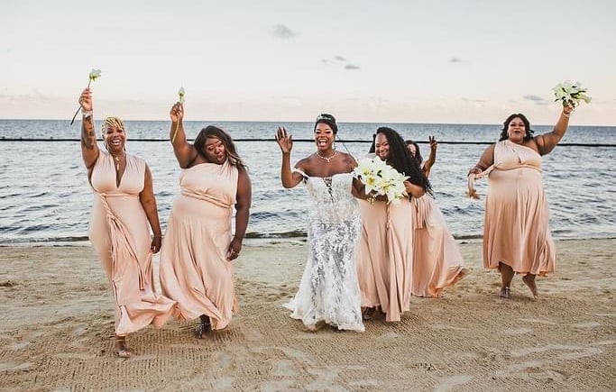 a bride and groomsmid are posing for a photo