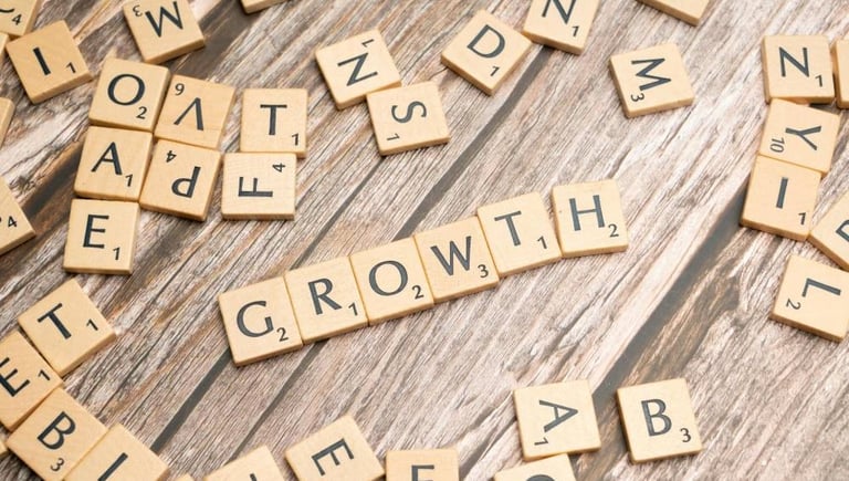 scrabble pieces spelling the word growth