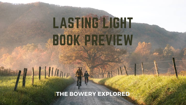 Gravel road in Cades Cove, Great Smoky Mountains, with two bikers during the fall by Nate Bowery