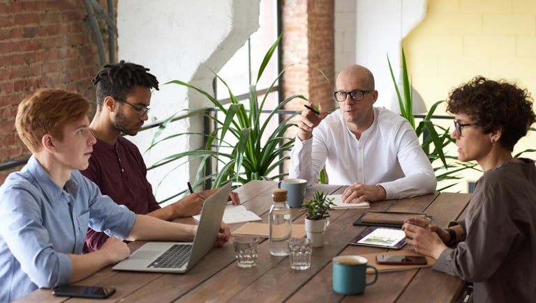 Diverse creative team having a business meeting at a table in a modern office.