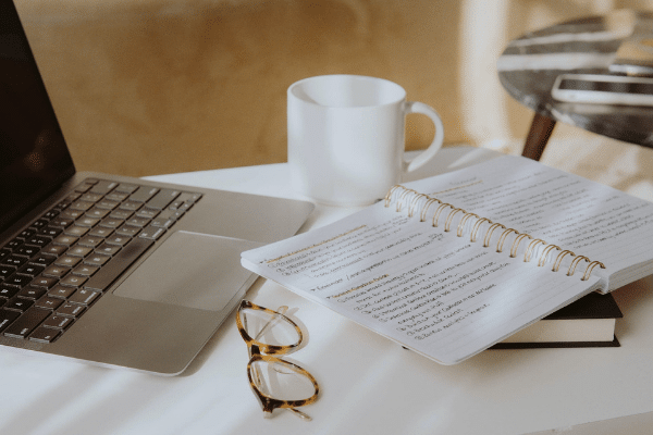 Woman reviewing notes and planning education goals at a desk