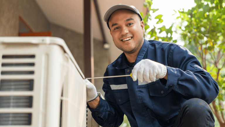 a man in a blue shirt and gloves is holding a wren and wren