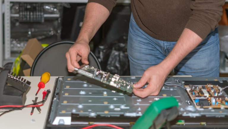 a man is holding a piece of electronic equipment