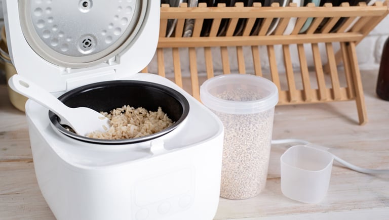 a rice cooker with rice and a bowl of rice