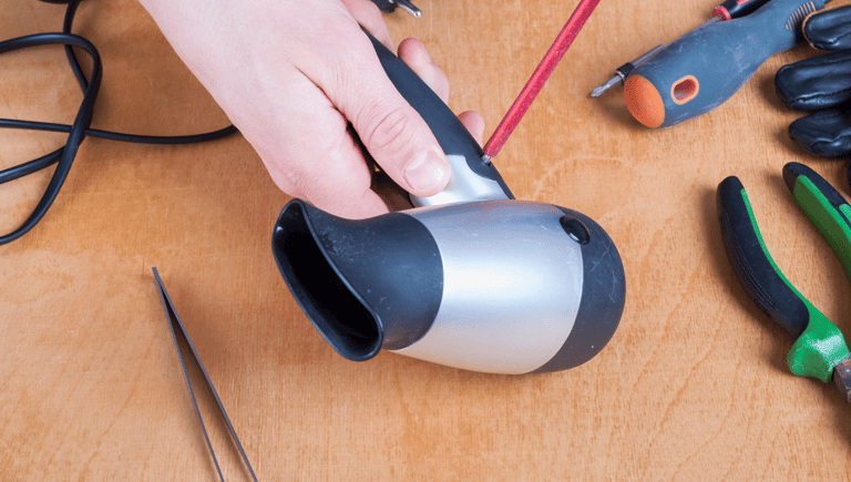 a person holding a hair dryer in their hand