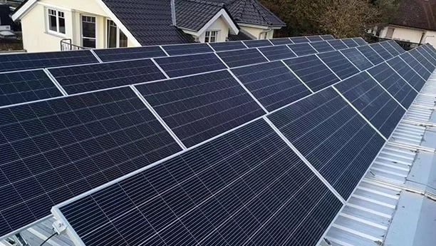 Residential rooftop solar panel installation for clean renewable energy on a modern home.