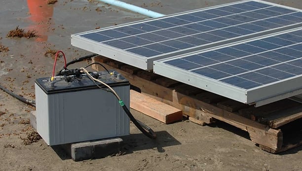 Portable solar panel array connected to a deep cycle battery for off-grid power generation.