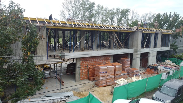 a building being built into a house with a roof that is being built into a