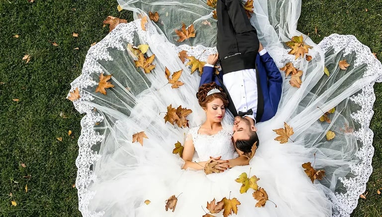 Wedding Photography - a bride and groom laying on the grass