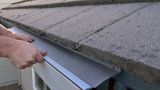 gutter guards being installed by studs gutters