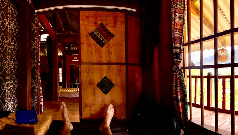 a person's feet on a bed in a homestay