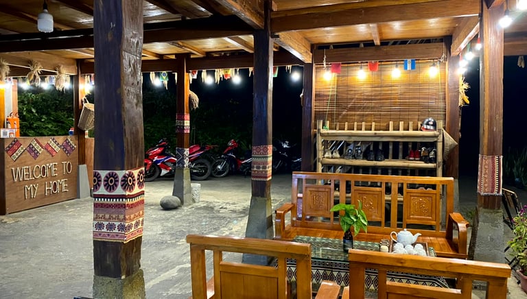 a homestay with a wooden table and chairs