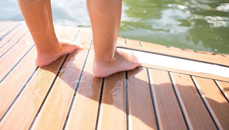 Feet standing on foam teak deck on a boat and enjoying the soft feel