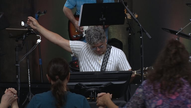 a man playing a keyboard and a woman singing