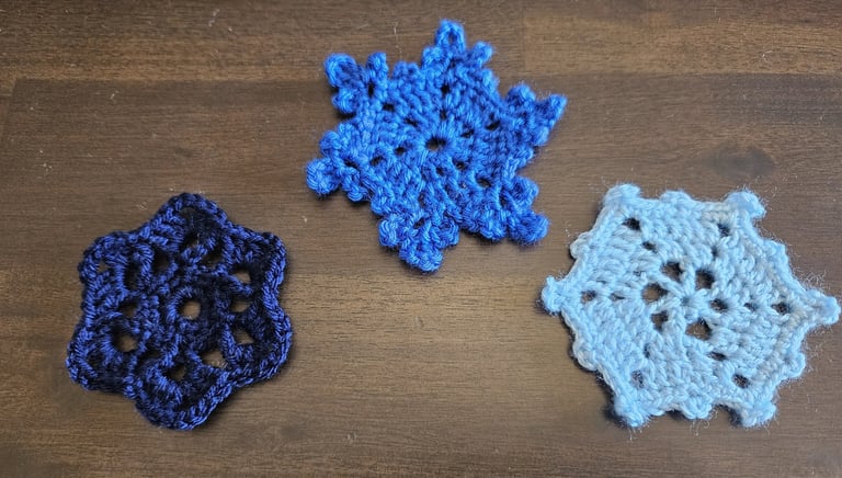 blue crochet snowflakes on a wooden background
