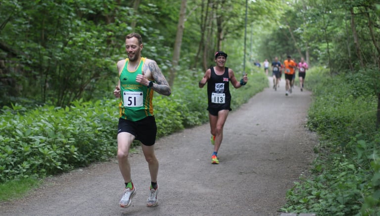 a man running on a path in a wooded area