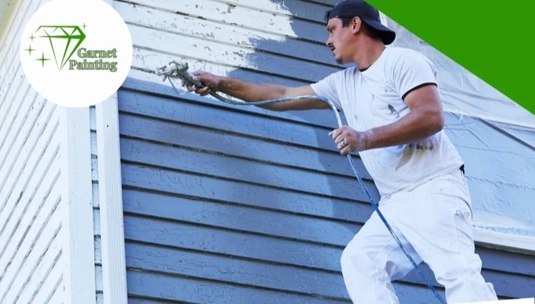 Garnet Painting team working on exterior house painting with company logo visible”