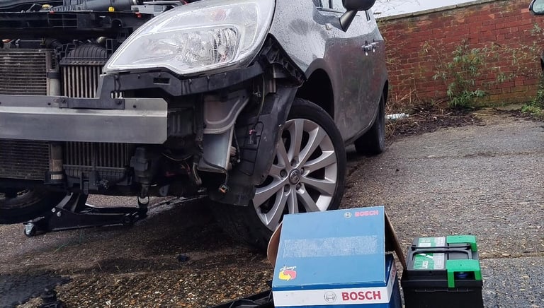 a car jacked up front bumper removed having alternator replaced