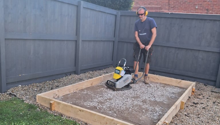 a man operating a compactor plate
