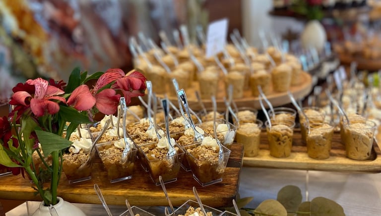 Food display of miniature desserts, fresh florals and food labels