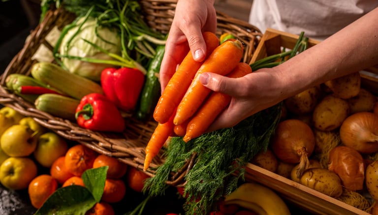 a person holding a bunch of carrots in a basket