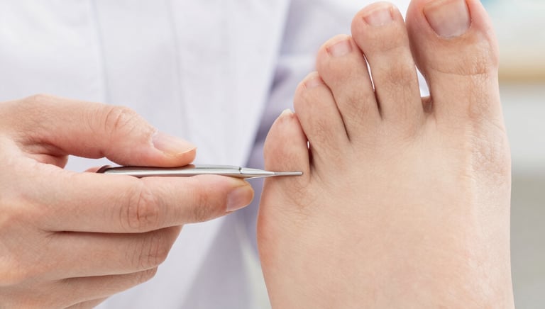 Close-up of a podiatrist examining a patient's foot with specialized tools in a modern clinic.