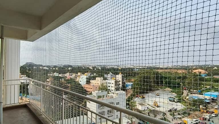 Anti-pigeon netting covering a commercial building's open areas.