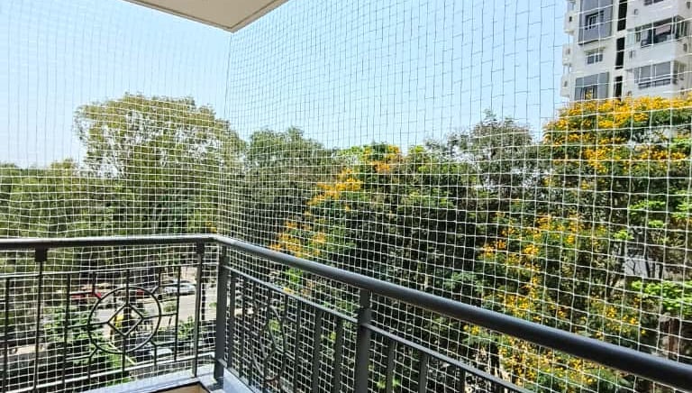 Close-up of a well-installed pigeon net on a modern balcony in Yelahanka.