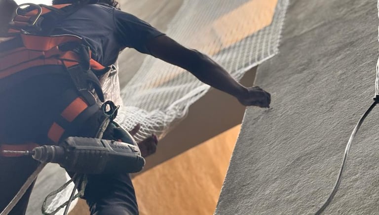Close-up of a technician installing a safety cover over an apartment duct in Velacherry.