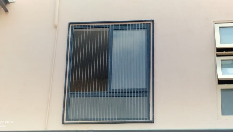 A technician carefully measuring a window frame installing an invisible grill in Mylapore chennai