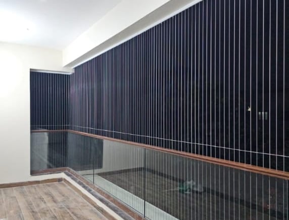 Close-up of a sleek, transparent invisible grill installed on a window in a modern home.