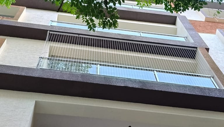 A wide shot showing a balcony with custom invisible grills in royapettah