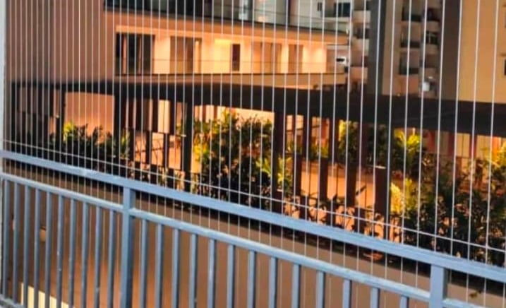 A close-up of a sleek invisible grill installed on a balcony in mylapore chennai