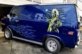 a van with a large painting on the side of it from Iron Maiden