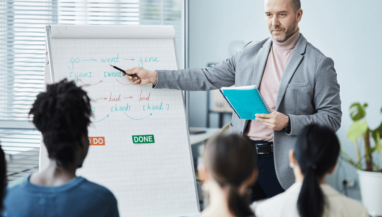 a man in a suit and tie is giving a presentation
