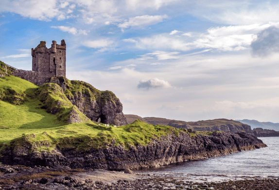 Ancient castle sitting on rocky cliff with water