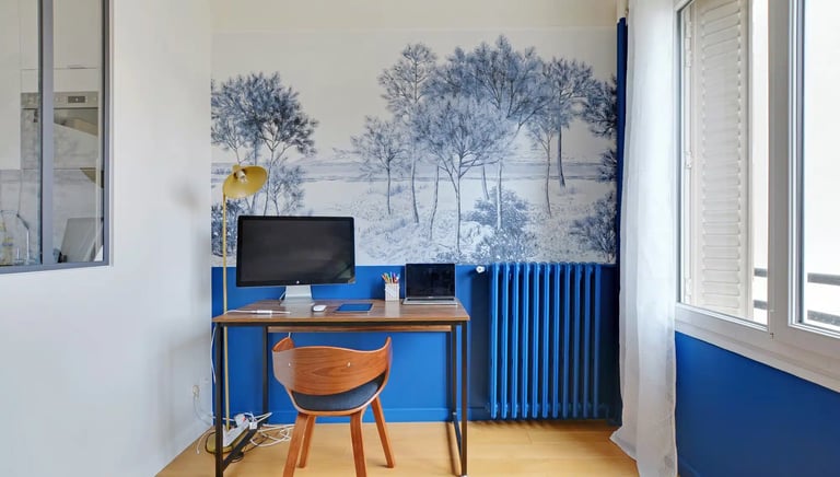 a desk with a computer and a chair